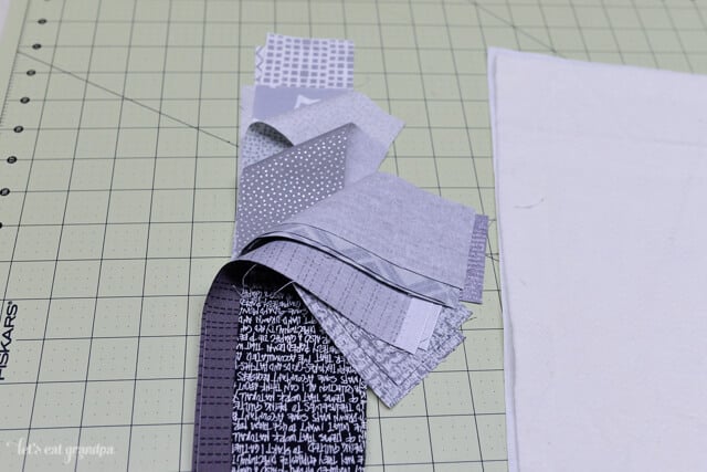 strips of gray fabric for QAYG tutorial