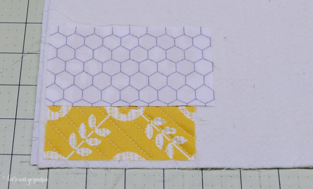 strip of fabric on each side of a fabric square on backing fabric