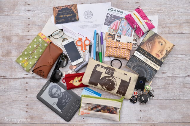 contents of a woman's purse: sunglasses, pens, wallet, book, scissors, etc.