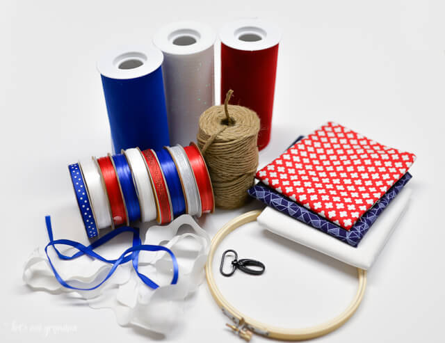 supplies needed to make a patriotic windsock - red, white, and blue ribbon, fabric, hoop, and twine