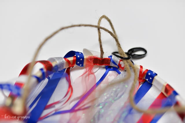twine attached to hoop to make patriotic windsock with red, white, and blue ribbon