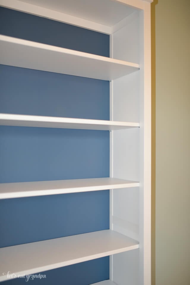 white bookshelf with blue back painted