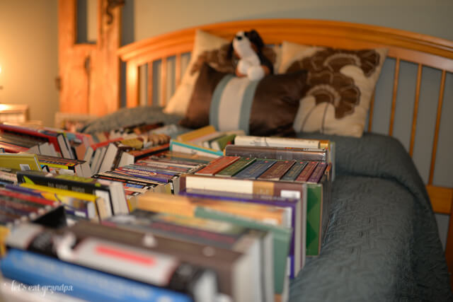 pile of books on bed