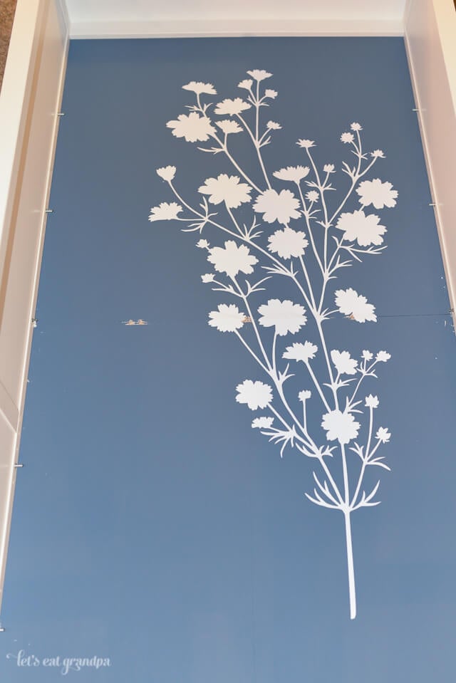 floral wall decal on blue bookshelf background