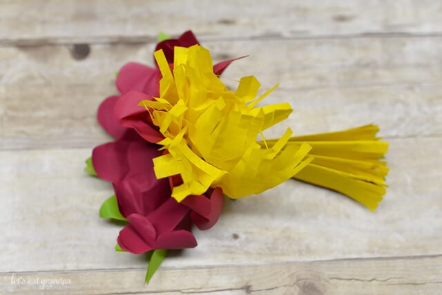 magenta, yellow, and green tissue paper flower fluffed out a bit 