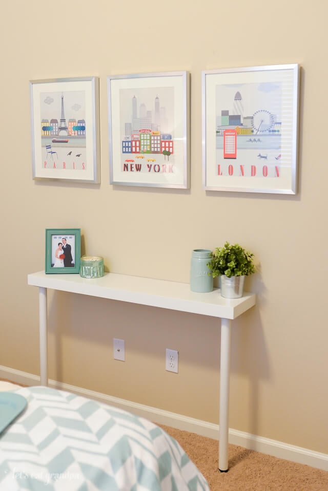 small side table with wall prints hung