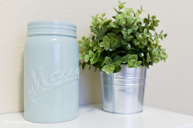 closeup of green plant and blue vase