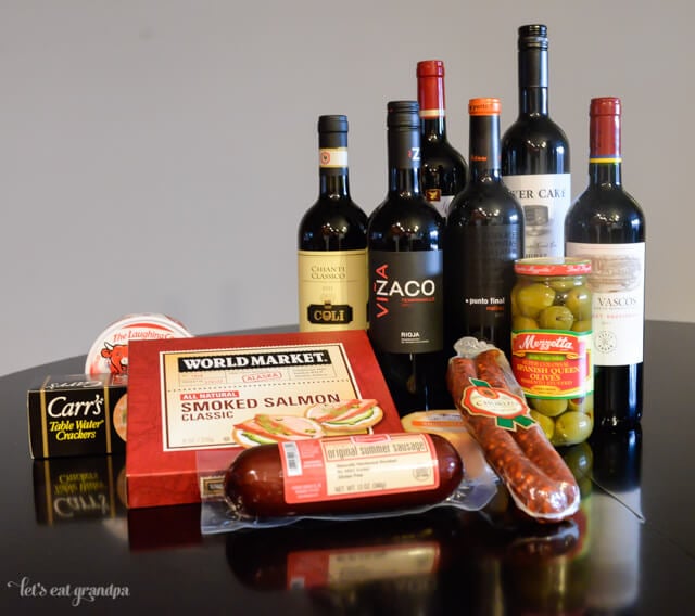 red wines, salami, olives, and smoked salmon for wine party