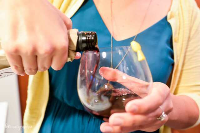 woman pouring red wine in glass