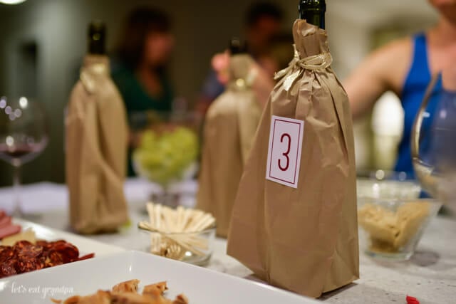 wine in brown bags with numbered labels