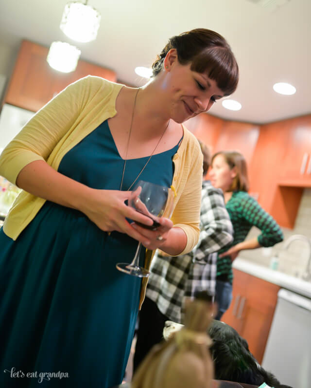 side angle of woman holding red wine