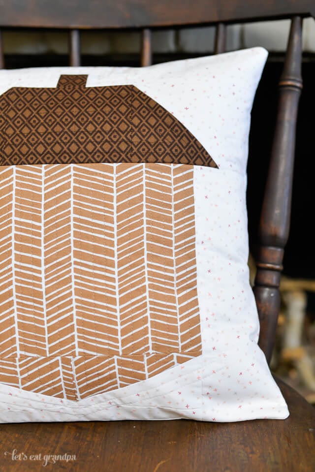 close up of finished acorn block pillow on rocking chair