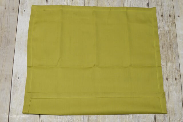 green napkin folded 1/4 