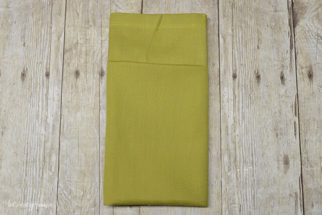 green napkin folded with a pocket