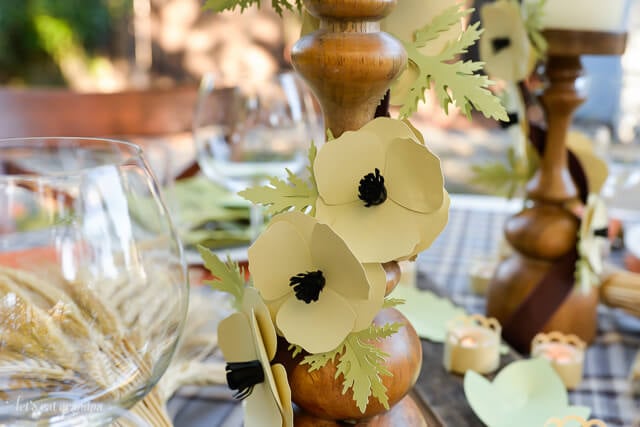 paper flowers on candle pillar for table decor