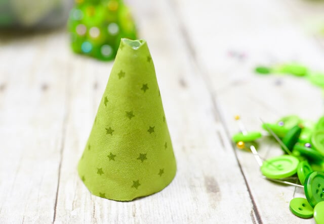 fabric wrapped around foam cone to make button Christmas craft