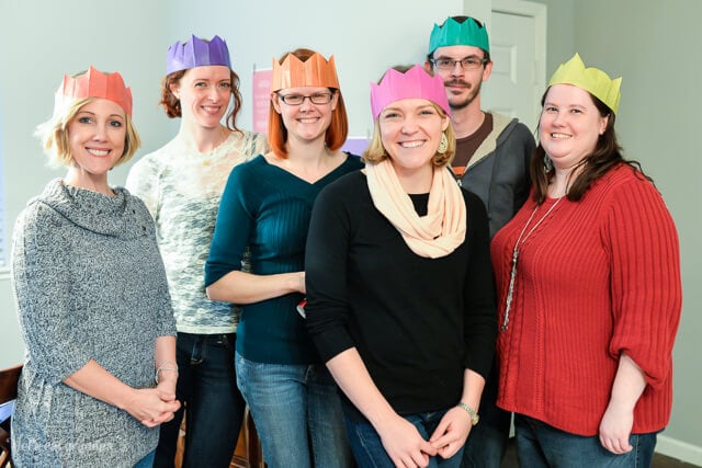 group of friends with paper crowns on